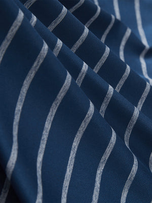 Close-up texture of navy peony/arctic white non-curl ribbed collar striped polo shirts fabric showing striped weave detail.
