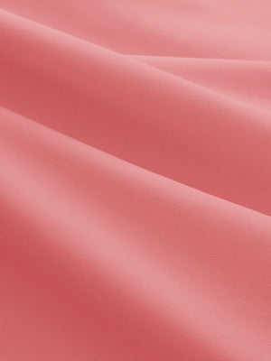 Close-up texture of pink women's 5 buttons collared polo shirts fabric showing detailed knit weave.