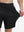 View showing loose fit of black 4 way stretch breathable workout athletic shorts