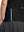 Detail view of hem design on black women's breathable 1/4 zip pullover golf shirts