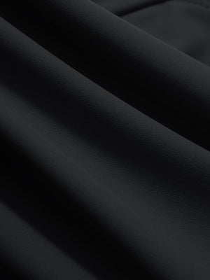 Close-up texture of black women's high waist stretch golf pants with pockets fabric showing weave detail.