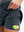 Inside view of pocket on dark grey high waist built-in short a-line golf skirt with 5 pockets